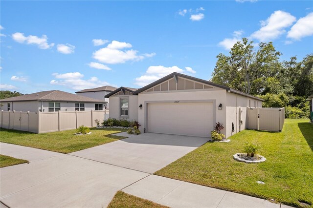 39024 Harlow Rose Dr, Zephyrhills, FL 33540 - view of front facade featuring a garage, driveway, and stucco siding