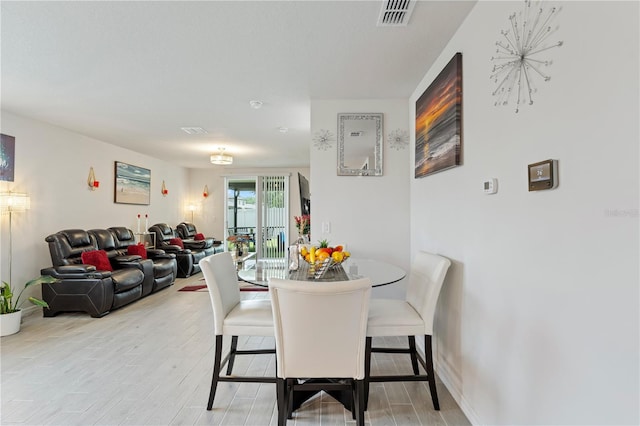 39024 Harlow Rose Dr, Zephyrhills, FL 33540 - dining room featuring light wood-type flooring