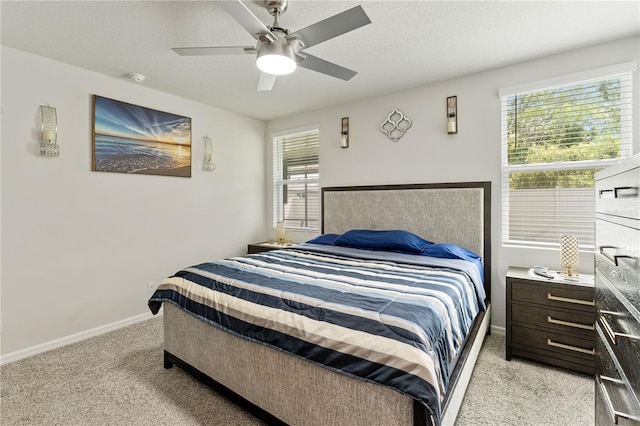 39024 Harlow Rose Dr, Zephyrhills, FL 33540 - bedroom featuring light carpet, multiple windows, and ceiling fan