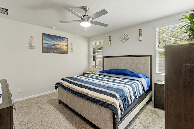 39024 Harlow Rose Dr, Zephyrhills, FL 33540 - bedroom with light colored carpet and ceiling fan