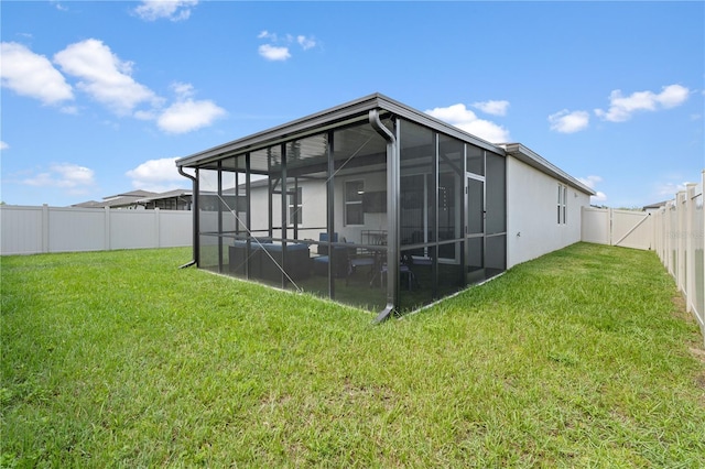 39024 Harlow Rose Dr, Zephyrhills, FL 33540 - back of house with a fenced backyard and a sunroom