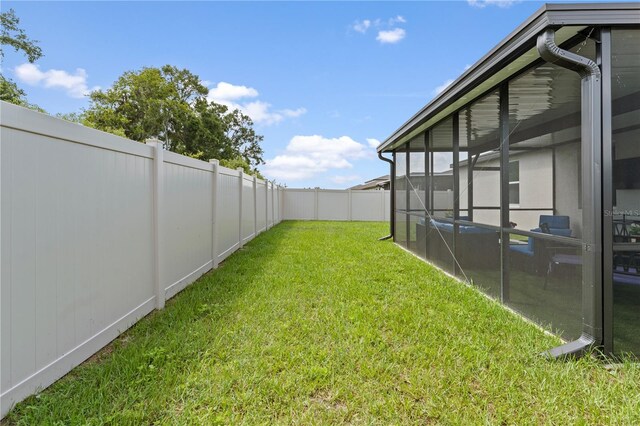 39024 Harlow Rose Dr, Zephyrhills, FL 33540 - fenced backyard featuring a sunroom