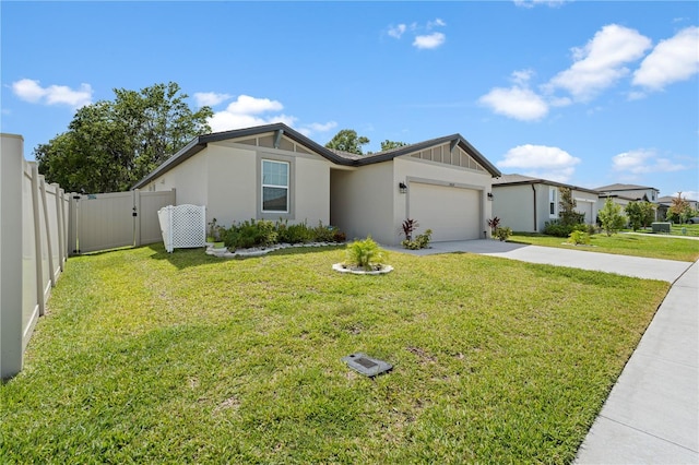 39024 Harlow Rose Dr, Zephyrhills, FL 33540 - view of front of house with driveway, an attached garage, stucco siding, and a gate