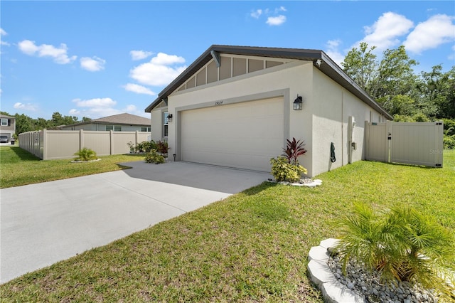 39024 Harlow Rose Dr, Zephyrhills, FL 33540 - view of home's exterior with an attached garage, concrete driveway, and stucco siding