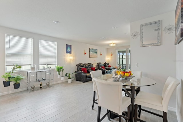 39024 Harlow Rose Dr, Zephyrhills, FL 33540 - dining room featuring light wood-style flooring and baseboards