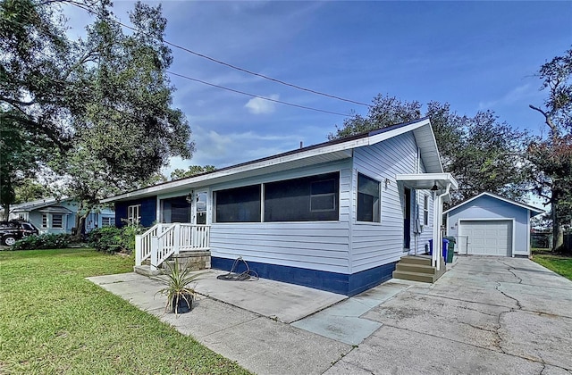 1938 E Fern Rd, Lakeland, FL 33801 - view of front of house with an outdoor structure, a front yard, a garage, and driveway