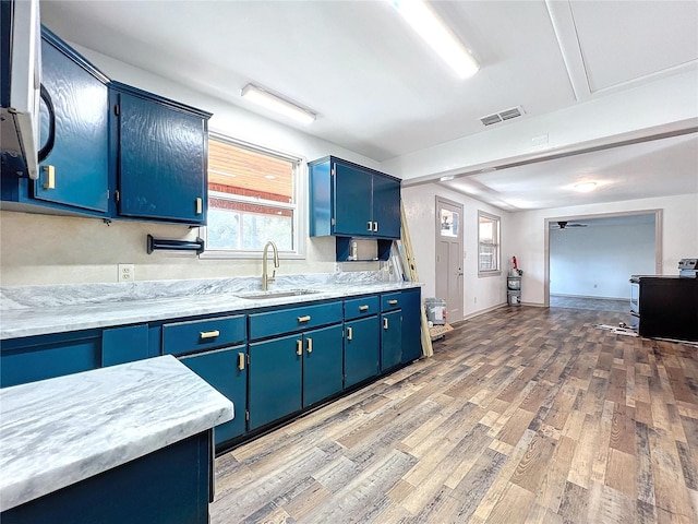 1938 E Fern Rd, Lakeland, FL 33801 - kitchen featuring blue cabinets, light wood-type flooring, electric range, and a ceiling fan