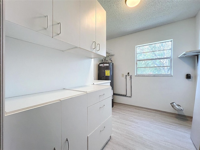 1938 E Fern Rd, Lakeland, FL 33801 - washroom featuring water heater, light wood-type flooring, and a textured ceiling