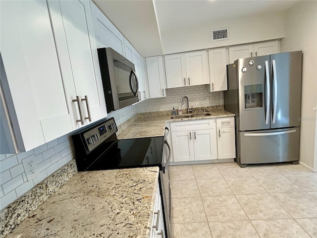 2070 World Parkway Blvd Unit 36, Clearwater, FL 33763 - kitchen with stainless steel fridge with ice dispenser, electric range oven, tasteful backsplash, and white cabinetry