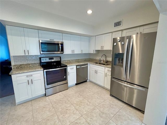 2070 World Parkway Blvd Unit 36, Clearwater, FL 33763 - kitchen with stainless steel appliances, tasteful backsplash, light stone counters, and recessed lighting