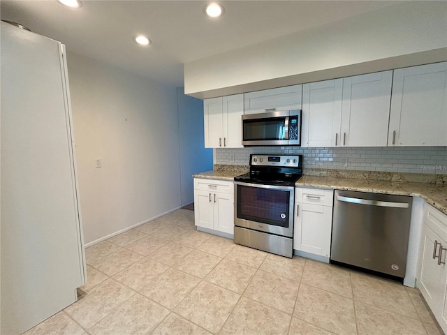 2070 World Parkway Blvd Unit 36, Clearwater, FL 33763 - kitchen with stainless steel appliances, backsplash, light stone countertops, recessed lighting, and white cabinets