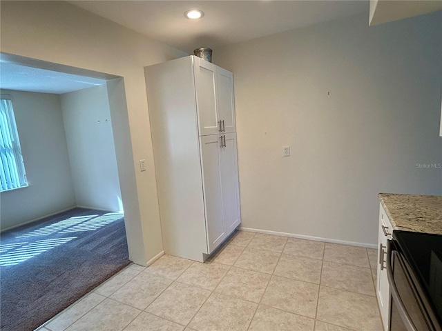 2070 World Parkway Blvd Unit 36, Clearwater, FL 33763 - kitchen with light tile patterned flooring, electric range, light colored carpet, light stone counters, and recessed lighting