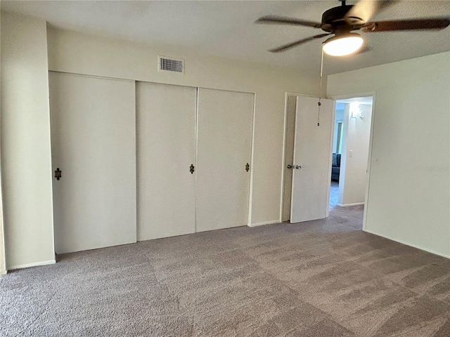 2070 World Parkway Blvd Unit 36, Clearwater, FL 33763 - unfurnished bedroom featuring carpet floors, a closet, and a ceiling fan