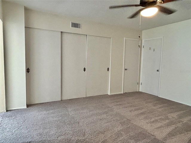 2070 World Parkway Blvd Unit 36, Clearwater, FL 33763 - unfurnished bedroom featuring carpet floors, a closet, and a ceiling fan