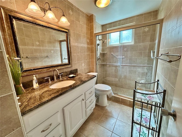 2070 World Parkway Blvd Unit 36, Clearwater, FL 33763 - full bathroom featuring tile walls, vanity, a stall shower, and tile patterned floors