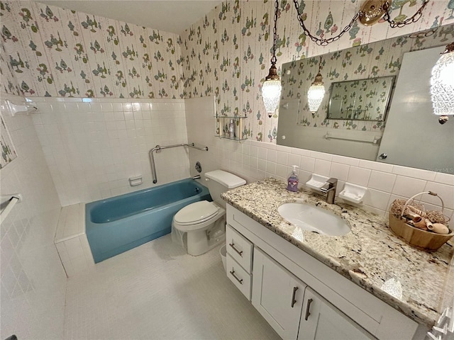 2070 World Parkway Blvd Unit 36, Clearwater, FL 33763 - full bath featuring wallpapered walls, tile walls, a bathtub, vanity, and tile patterned floors