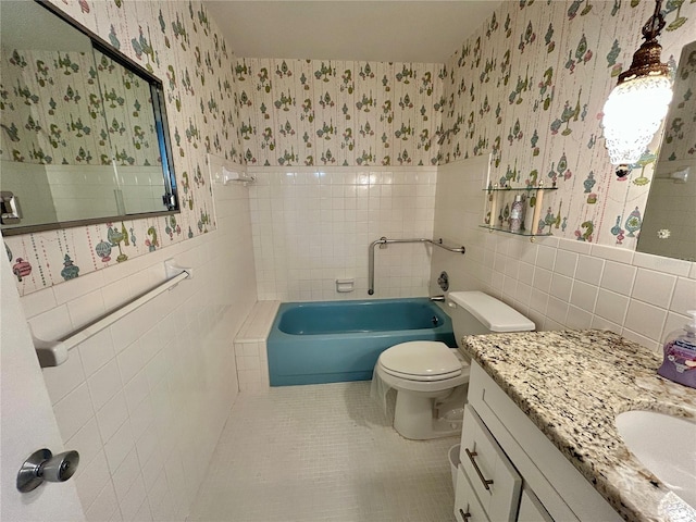 2070 World Parkway Blvd Unit 36, Clearwater, FL 33763 - full bathroom featuring tile walls, wallpapered walls, a tub to relax in, tile patterned flooring, and vanity