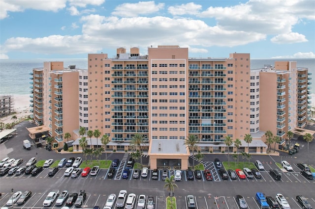 880 Mandalay Ave Unit C513, Clearwater Beach, FL 33767 - view of apartment building / complex featuring a water view and uncovered parking