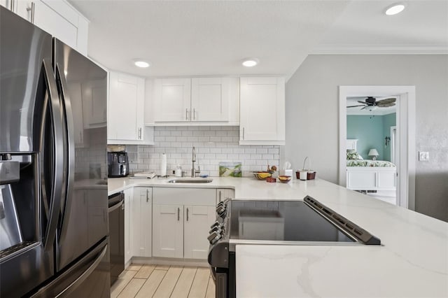 880 Mandalay Ave Unit C513, Clearwater Beach, FL 33767 - kitchen featuring stainless steel appliances, tasteful backsplash, white cabinets, crown molding, and light stone countertops