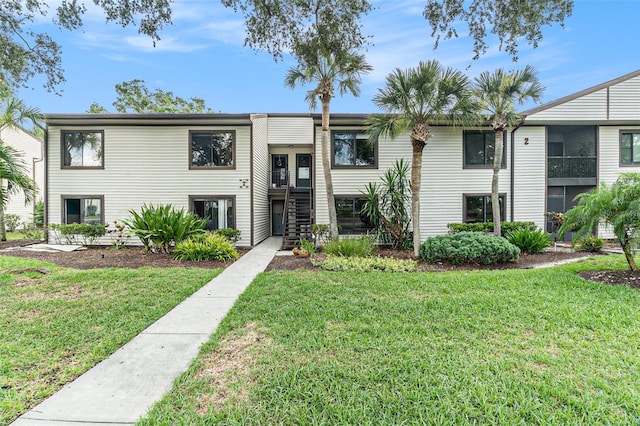 326 Moorings Cove Dr Unit 2B, Tarpon Springs, FL 34689 - multi unit property with a front lawn and stairway
