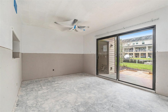 326 Moorings Cove Dr Unit 2B, Tarpon Springs, FL 34689 - empty room featuring unfinished concrete flooring, a textured ceiling, and ceiling fan
