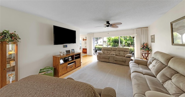 3035 Countryside Blvd Unit 16B, Clearwater, FL 33761 - living room featuring ceiling fan and a textured ceiling