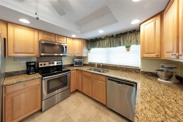 3035 Countryside Blvd Unit 16B, Clearwater, FL 33761 - kitchen with stainless steel appliances, a raised ceiling, recessed lighting, light stone countertops, and light tile patterned flooring