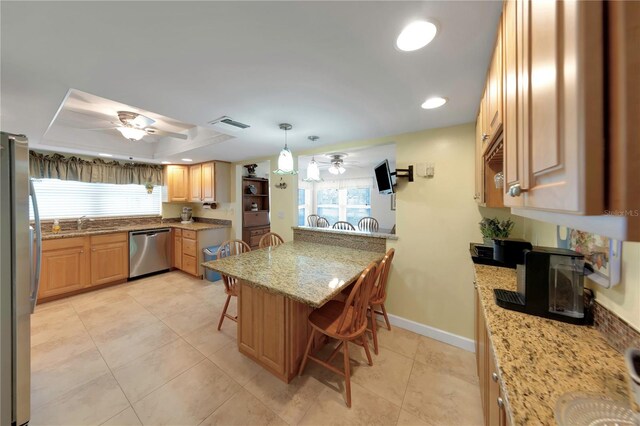 3035 Countryside Blvd Unit 16B, Clearwater, FL 33761 - kitchen featuring appliances with stainless steel finishes, ceiling fan, a kitchen bar, plenty of natural light, and recessed lighting