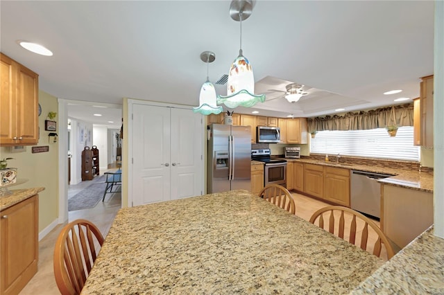 3035 Countryside Blvd Unit 16B, Clearwater, FL 33761 - kitchen featuring stainless steel appliances, light stone counters, ceiling fan, decorative light fixtures, and recessed lighting