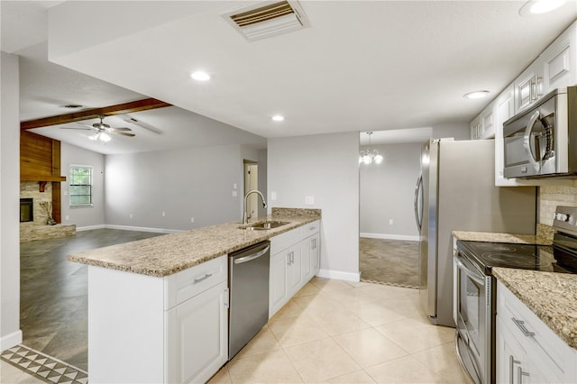 3753 Thornbush Ln, New Port Richey, FL 34655 - kitchen featuring appliances with stainless steel finishes, a peninsula, a ceiling fan, white cabinets, and recessed lighting