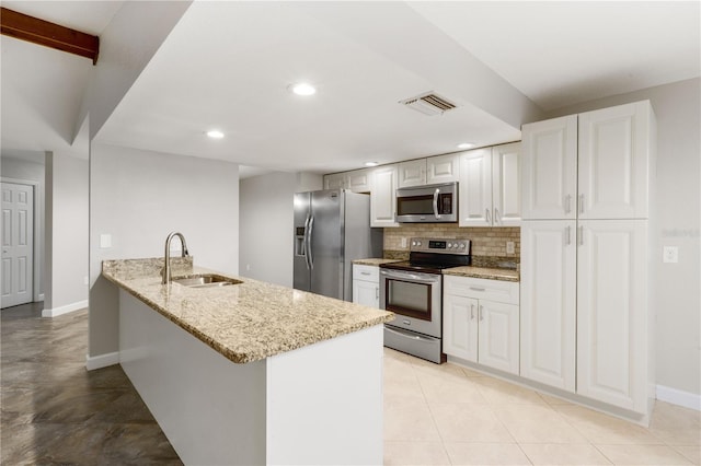 3753 Thornbush Ln, New Port Richey, FL 34655 - kitchen with appliances with stainless steel finishes, light stone counters, backsplash, white cabinets, and recessed lighting