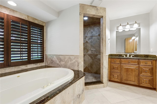 3753 Thornbush Ln, New Port Richey, FL 34655 - full bath featuring a garden tub, vanity, tile patterned floors, and a tile shower