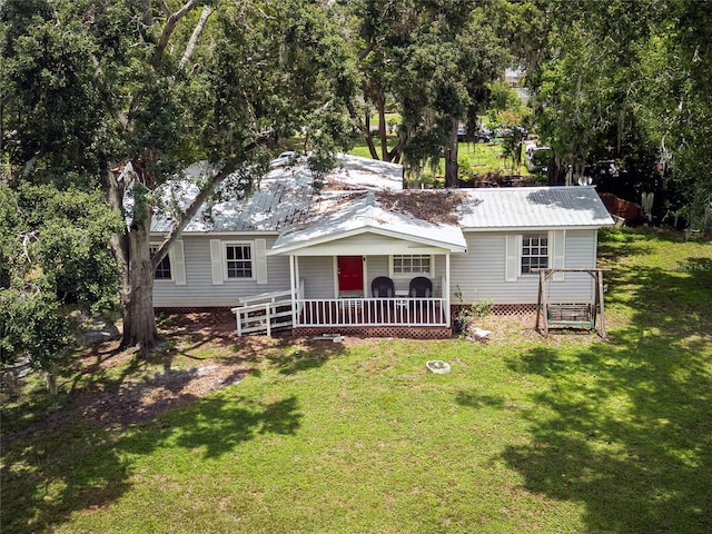 11704 Orange Grove Ter, Riverview, FL 33569 - view of front of home featuring a front lawn, a metal roof, and a porch
