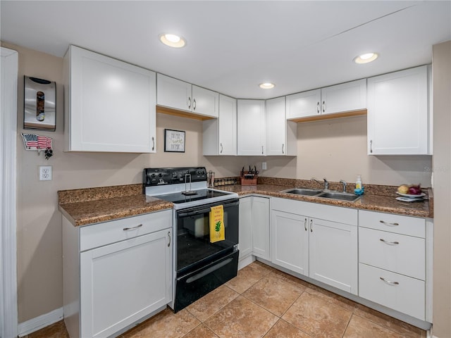 11704 Orange Grove Ter, Riverview, FL 33569 - kitchen featuring black electric range, white cabinets, dark countertops, recessed lighting, and light tile patterned floors