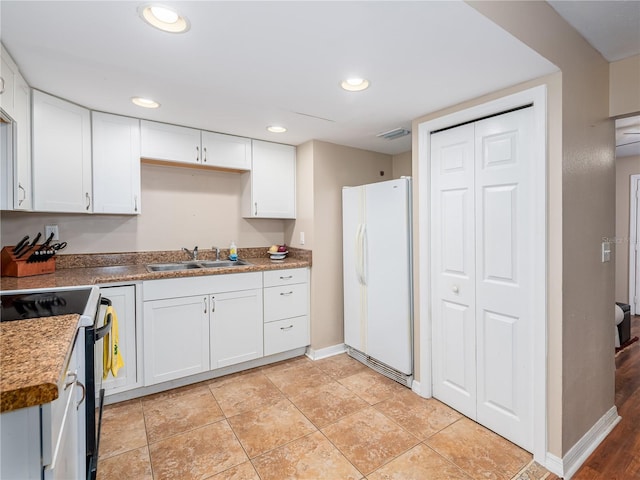 11704 Orange Grove Ter, Riverview, FL 33569 - kitchen with freestanding refrigerator, electric range oven, white cabinetry, and recessed lighting