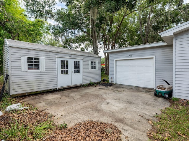 11704 Orange Grove Ter, Riverview, FL 33569 - garage featuring concrete driveway and french doors