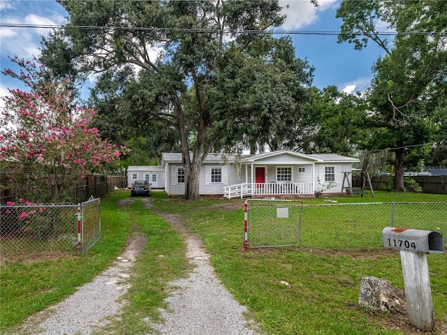 11704 Orange Grove Ter, Riverview, FL 33569 - view of front facade with driveway, a porch, and a fenced front yard