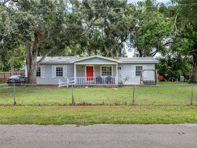 11704 Orange Grove Ter, Riverview, FL 33569 - single story home featuring a fenced front yard, a metal roof, and a porch