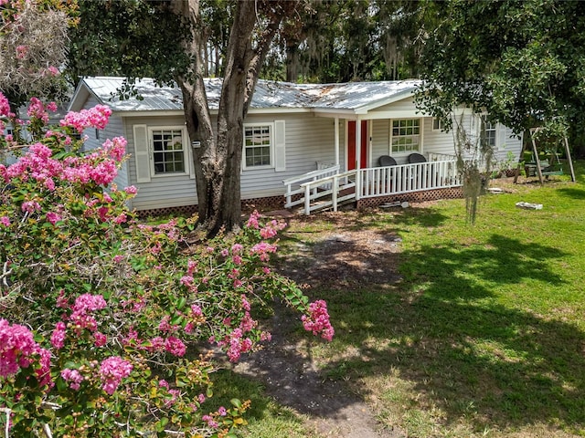 11704 Orange Grove Ter, Riverview, FL 33569 - ranch-style home featuring a porch, a front yard, and a metal roof