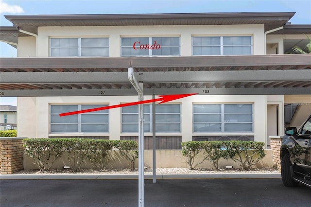 5111 Amulet Dr Unit 208, New Port Richey, FL 34652 - view of building exterior featuring covered parking