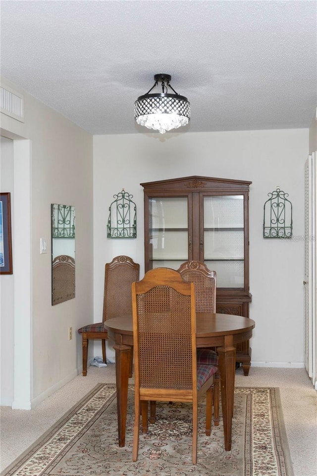 5111 Amulet Dr Unit 208, New Port Richey, FL 34652 - dining space with light carpet and a textured ceiling