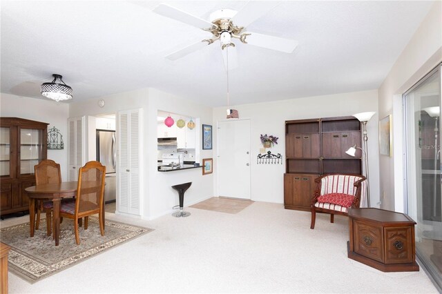 5111 Amulet Dr Unit 208, New Port Richey, FL 34652 - dining room with carpet floors and a ceiling fan