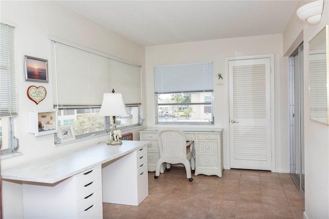 5111 Amulet Dr Unit 208, New Port Richey, FL 34652 - office area with built in desk and light tile patterned floors