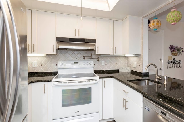 5111 Amulet Dr Unit 208, New Port Richey, FL 34652 - kitchen featuring stainless steel appliances, under cabinet range hood, tasteful backsplash, and dark stone counters