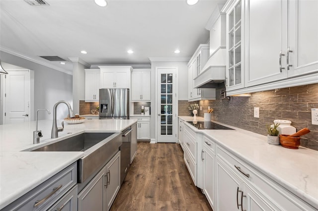 12121 Rustic River Way, Tampa, FL 33635 - kitchen featuring stainless steel appliances, crown molding, white cabinets, premium range hood, and glass insert cabinets