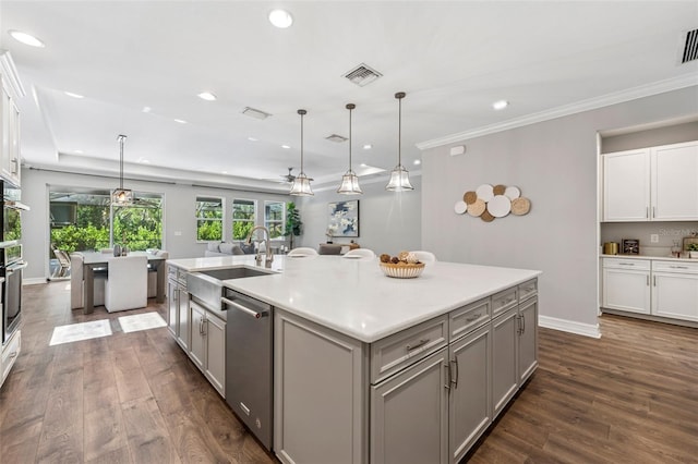 12121 Rustic River Way, Tampa, FL 33635 - kitchen with stainless steel appliances, gray cabinetry, dark wood-style flooring, an island with sink, and hanging light fixtures