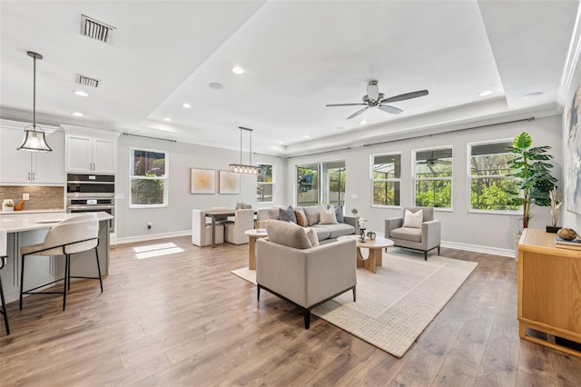 12121 Rustic River Way, Tampa, FL 33635 - living area with a tray ceiling, plenty of natural light, recessed lighting, ceiling fan, and crown molding
