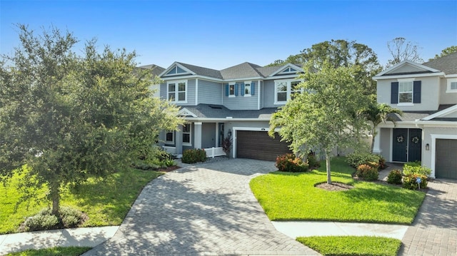 12121 Rustic River Way, Tampa, FL 33635 - view of front of property with a garage, driveway, a front lawn, stucco siding, and roof with shingles