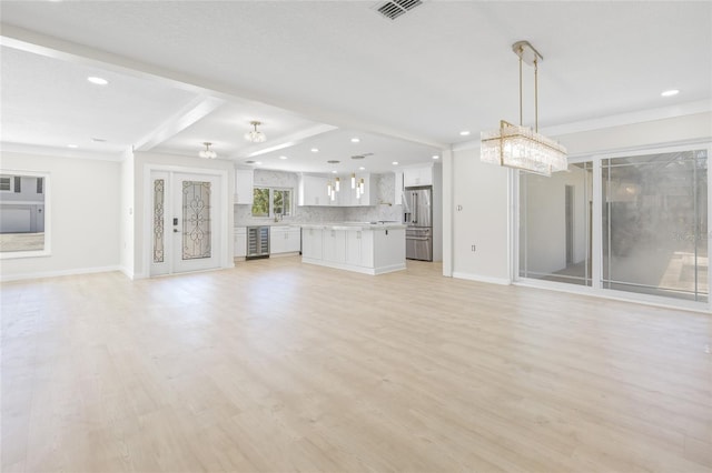 6400 Mockingbird Way S, Saint Petersburg, FL 33707 - unfurnished living room with wine cooler, light wood-style floors, recessed lighting, a chandelier, and beamed ceiling