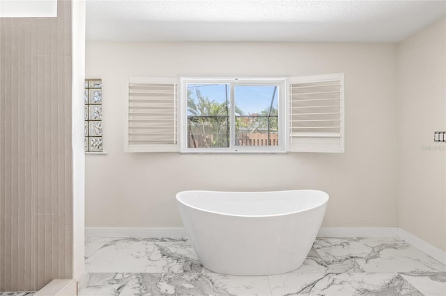 6400 Mockingbird Way S, Saint Petersburg, FL 33707 - bathroom with marble look tiles and a freestanding bath